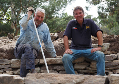 Cr Andrew Tilley and Greg Szymaniak building the dry stone wall