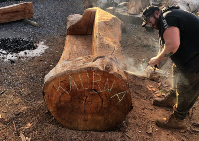 Kaurna artist Allan Sumner carving log seats